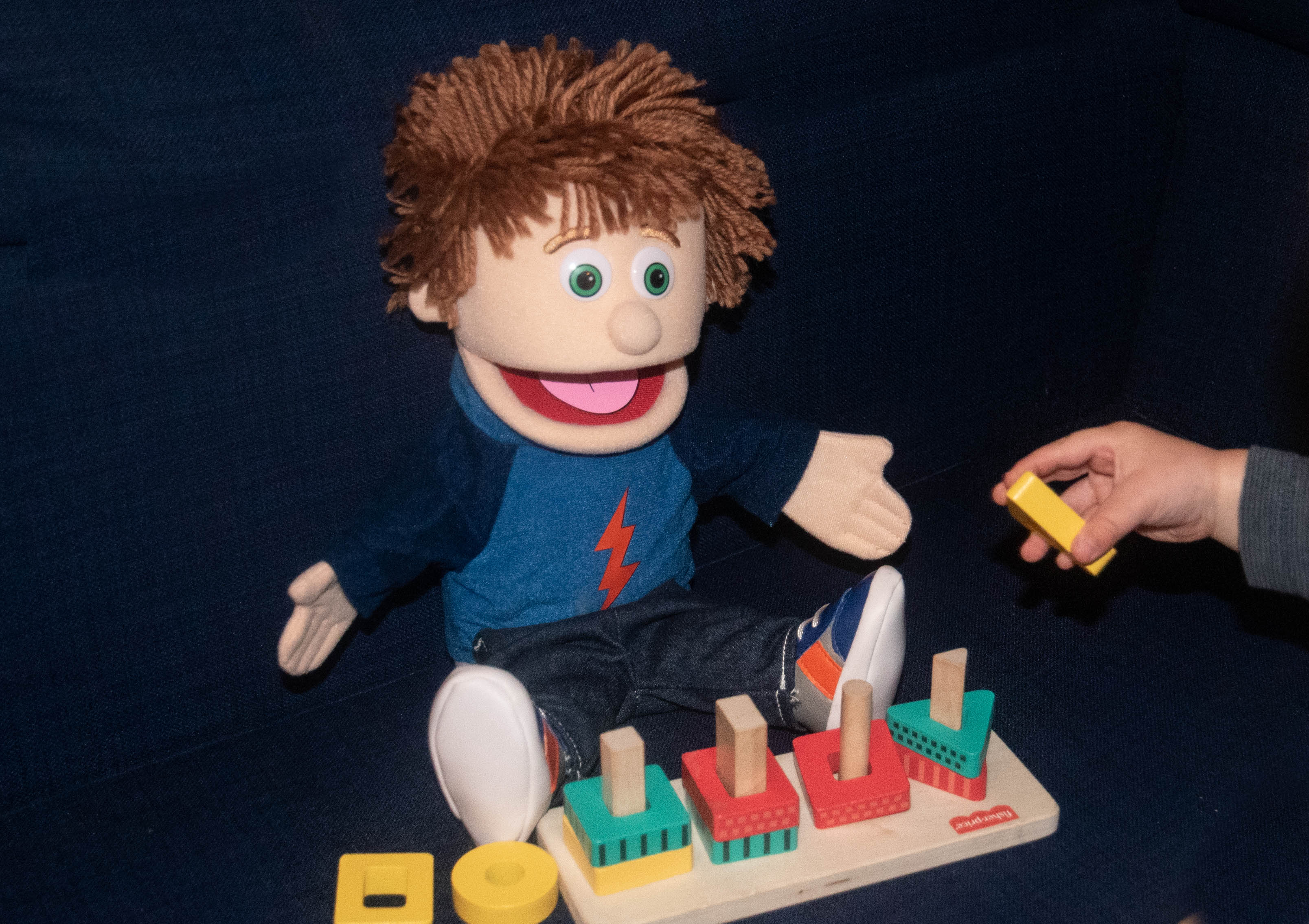Therapy session with puppet and developmental toys